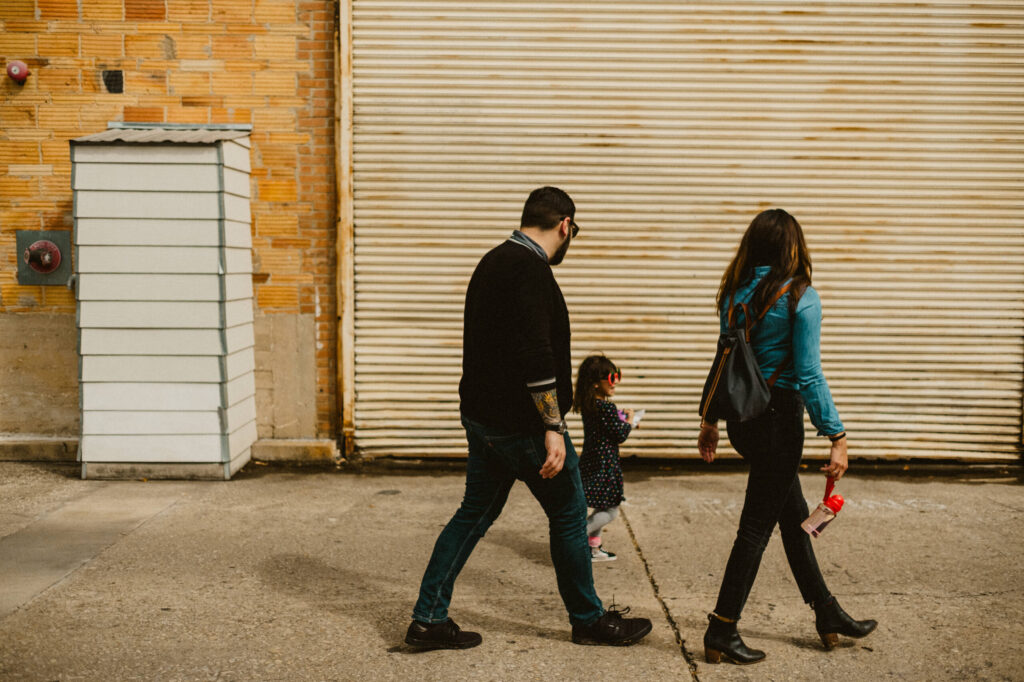 Family walking on urban pavement.