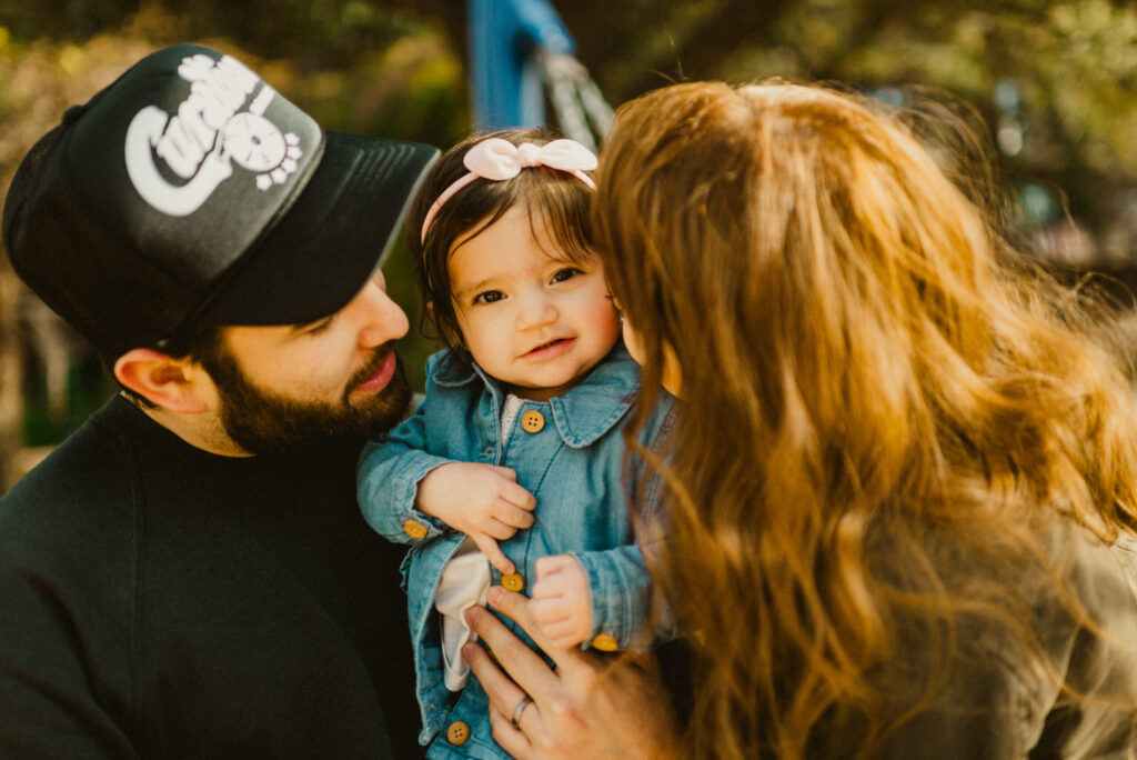 Family with baby in cozy outdoor setting.