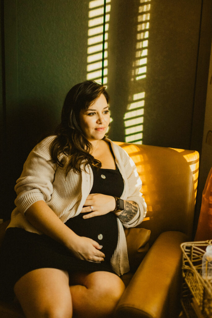 Pregnant woman relaxing in a sunlit chair.