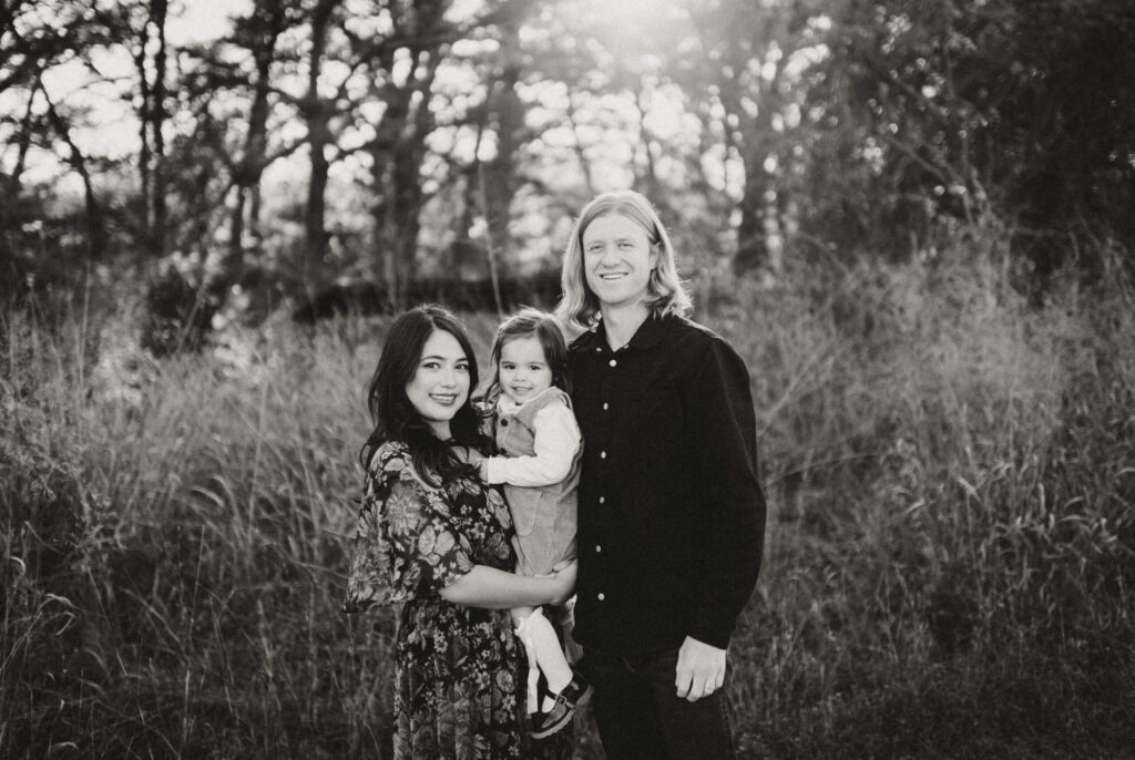 Family portrait in a field, black and white photo.